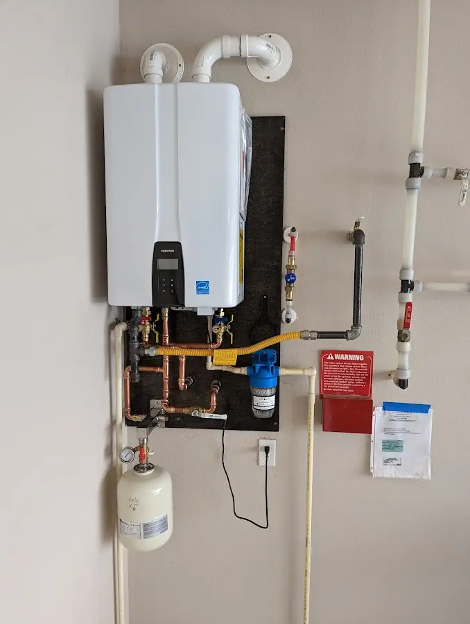 Professional plumber installing copper piping in a Forks home